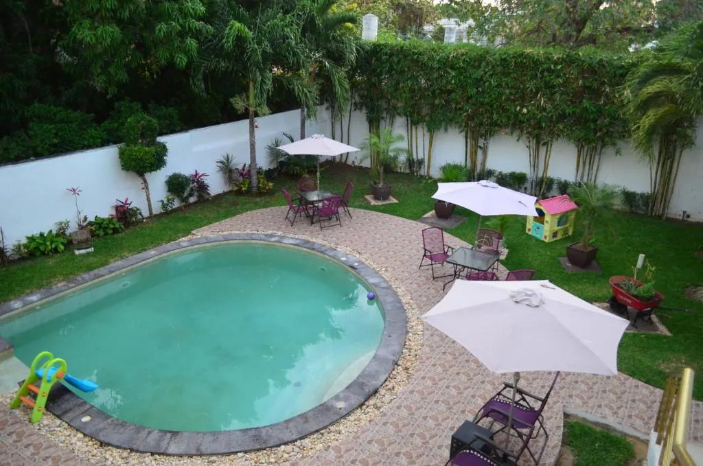 Garden pool and shaded terrace at Hotel Real Mercedes